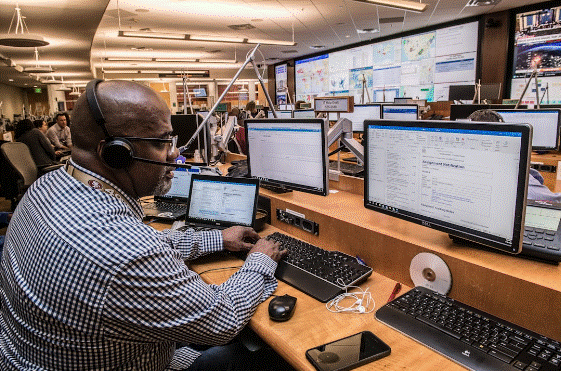 Call center agent wearing headset using contact center solutions on desktop computer